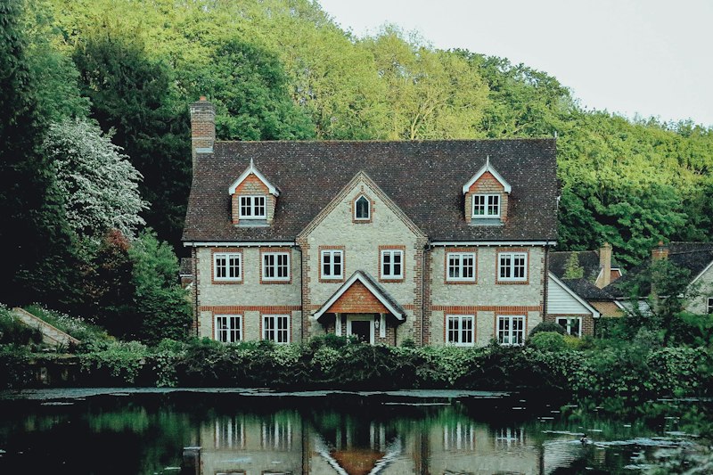 Stone home with a broad lawn and mixed borders