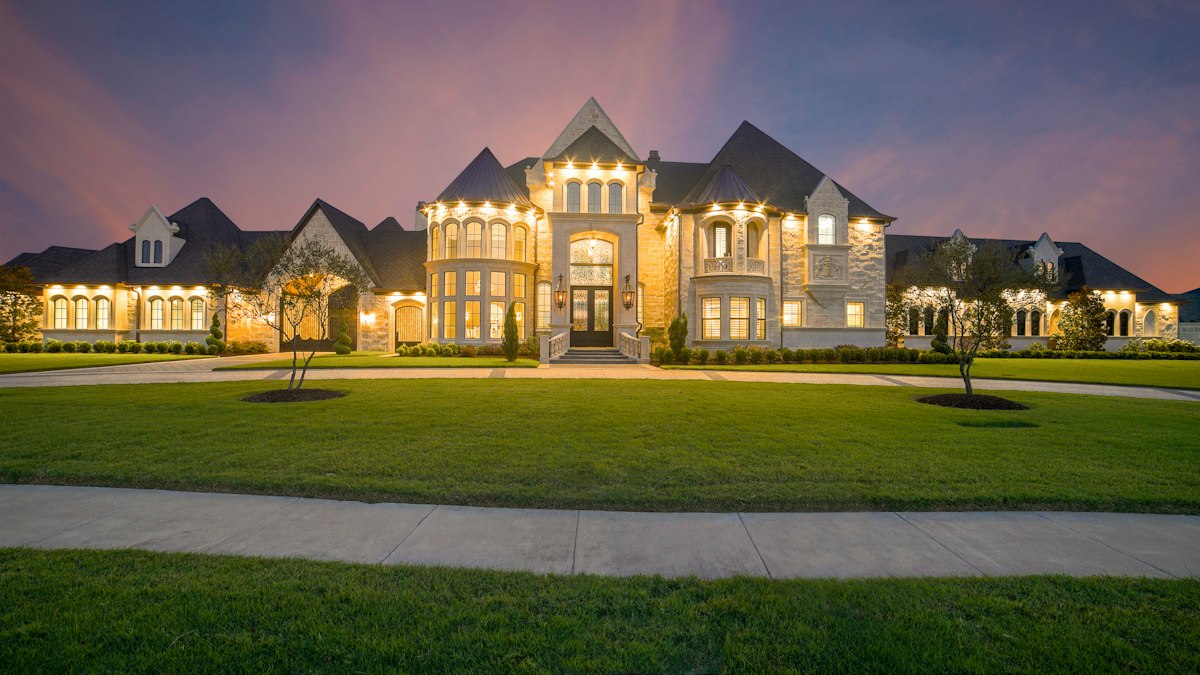 Estate home with a broad manicured lawn
